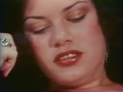 On the couch, a short-haired, breastless lesbian copulates with her lustful friend using a sex equipment.